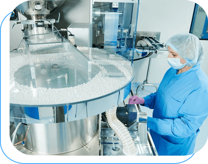 A person in blue lab coat and mask working on machine.